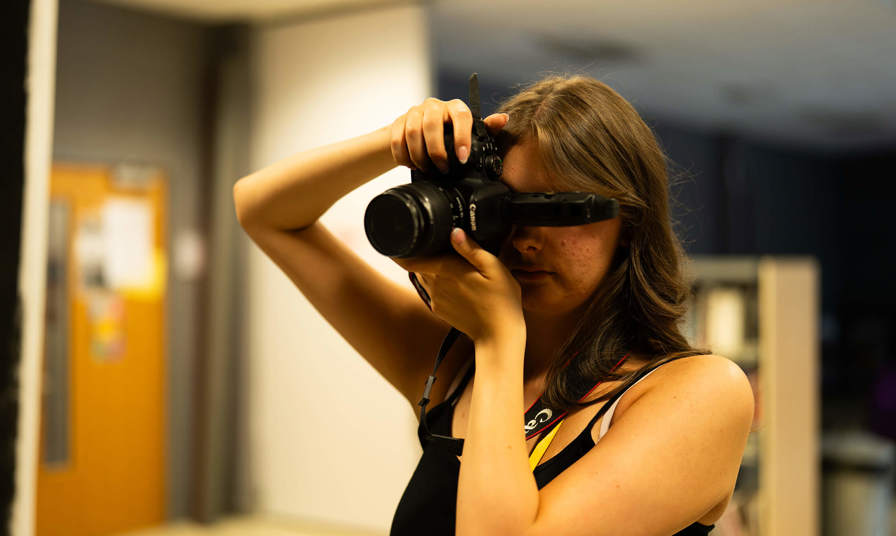 Young girl using a canon camera for photography