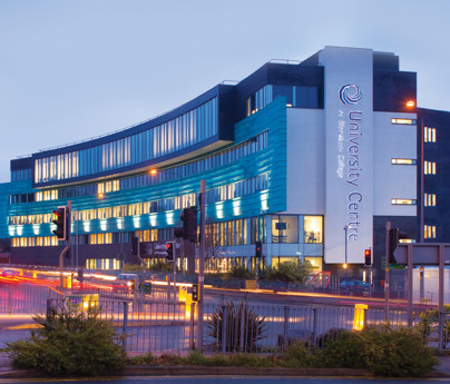University Centre Blackburn College lit at night view from road