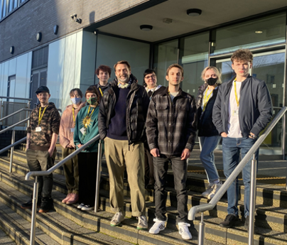 Patrick Grant with group of students stood on University Centre Blackburn College steps