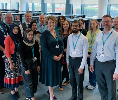 mixed group of staff from Blackburn Sixth form stood in library
