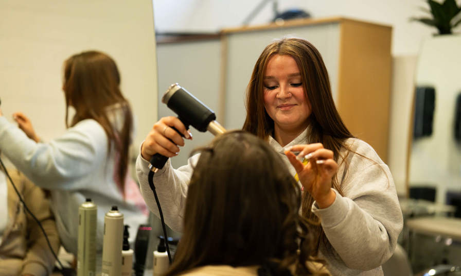 Female student styling hair